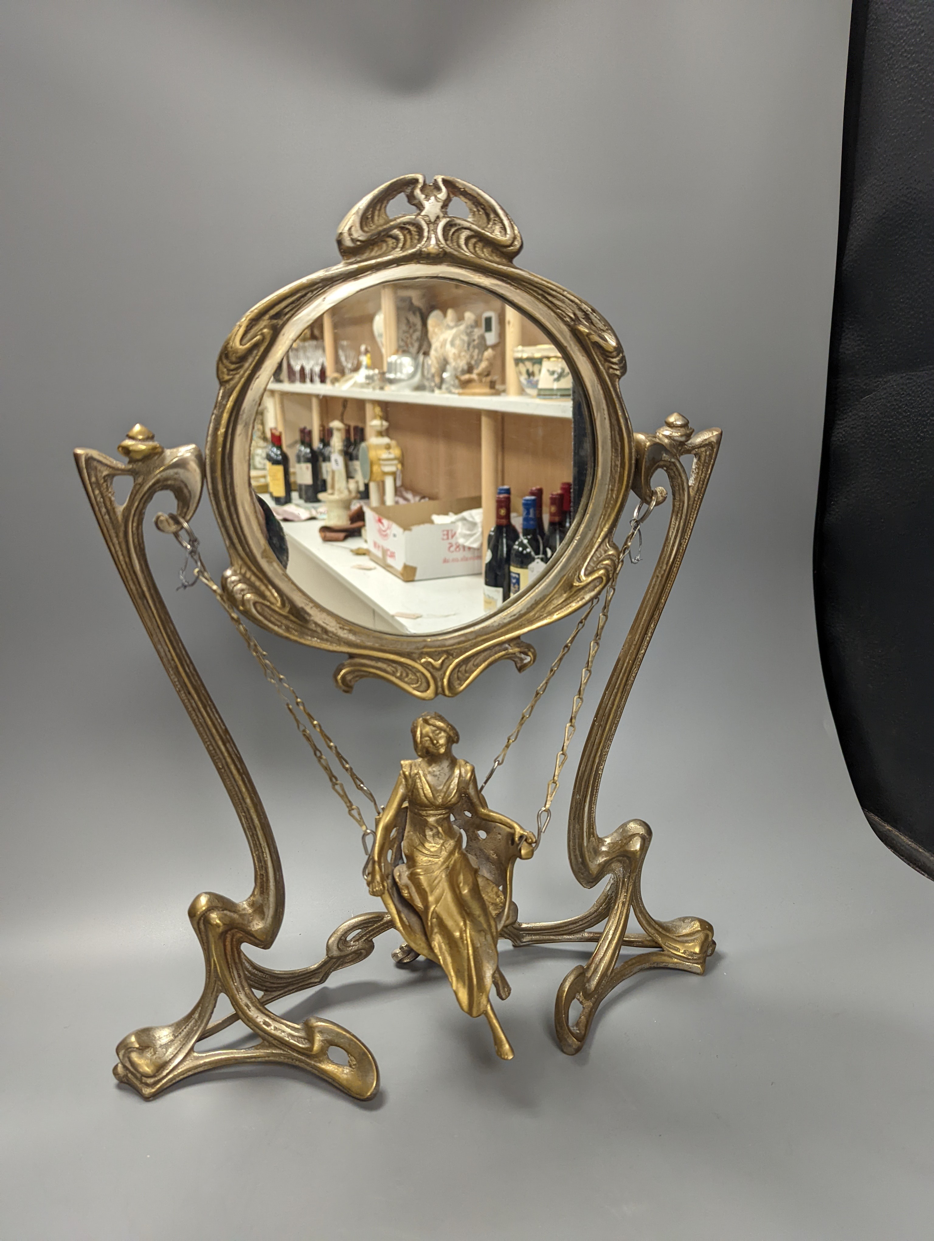 An Art Nouveau style mirror with model of girl sitting on a swing, height 45cm